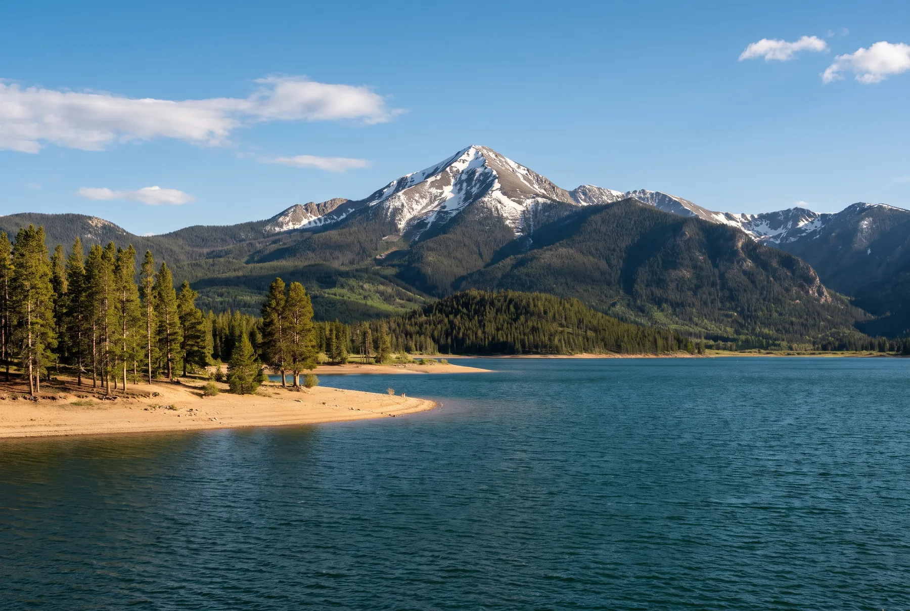 Lake Dillon in early summer with snow on Peak One behind